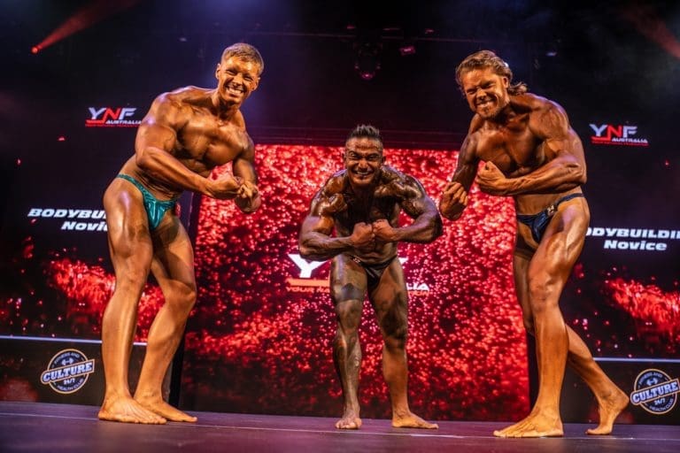 Male bodybuilders posing on stage for the camera